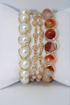 "Bracelet Stack, Pearl Bracelet Stack, Orange Bracelet Stack, Bead Bracelet Set, Beaded Bracelet Stack, Gemstone Bracelet Introducing our Fire Agate Bracelet Stack. With its sleek and timeless design, this bracelet stack effortlessly complements any outfit, whether it's for a casual day out or a special occasion. Bracelet set includes our popular Pearl Bracelet, Beige Wrap Bracelet, and a Orange Bead Bracelet.  The bracelet can be customized to any size wrist! XS: 6\" wrist S: 6.5\" wrist M: 7\" wrist L: 7.5\" wrist XL: 8\" wrist *custom sizing available free of charge*" Pearl Bracelet Stack, Bracelet Trio, Beaded Bracelet Stack, Orange Bracelet, Fire Agate, Agate Bracelet, Bracelet Stack, Gemstone Bracelet, Bead Bracelet