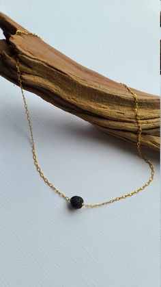 "Pele's Choker Necklace You can customize this black lava necklace to suit your personal style with your choice of sterling silver, 14k gold filled or 14k rose gold filled material. The model is wearing the 15\" length chain. D E T A I L S * Lava Bead Size: Approx 8mm * Chain Length: 14\" to 20\" For use with essential oils, add a drop or two of your favorite 100% pure therapeutic grade essential oil on to the lava beads, allow it soak in and enjoy the aromatherapy! Lava rocks are very porous an Everyday Spiritual Lava Stone Jewelry, Casual Beaded Lava Stone Jewelry, Minimalist Adjustable Lava Stone Jewelry, Black Lava Stone Necklace For Gift, Elegant Adjustable Lava Stone Jewelry, Elegant Black Lava Stone Jewelry, Black Lava Stone Round Bead Necklaces, Black Lava Stone Bohemian Jewelry, Layered Necklaces Boho