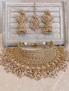 Flexible antique gold bridal jewellery set Sukhi, made up of clear and pink zircon crystals and small light pink crystal beads.  Necklace comes complete with matching tikka, and earrings. Necklace is adjustable to fit any size.  Ready to ship as seen with gift box. Pink Bridal Jewellery, Gold Bridal Jewellery, Bridal Survival Kit, Light Pink Crystal, Crystal Beads Necklace, Bridal Jewellery Set, Bridal Jewelry Sets Brides, Bangle Box, Pink Zircon