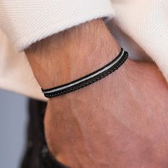 Looking for a gift for your man? You've found the perfect item for this!  Introducing a simple and beautiful bracelet for men that exudes effortless style and masculinity. This unique piece is composed of 4 layers of black stainless steel chains, creating a sleek and modern look that is perfect for everyday wear or special occasions. Make a bold statement with this versatile accessory that will complement any outfit and add a touch of edge to your wardrobe. Elevate your style with this trendy and contemporary bracelet that is sure to become a staple in your collection.  A perfect gift for the fashion-forward man in your life. Water proof Fits 6.7"-7.5" wrist sizes. The bracelet comes with 2" (5 cm) extension chain.  Item will arrive in a pretty gift wrap, ready to give, with my brand logo. Minimalist Jubilee Bracelet For Father's Day, Modern Black Bracelet As A Gift, Modern Black Bracelets For Friendship, Adjustable Black Minimalist Chain Bracelet, Minimalist Adjustable Black Chain Bracelet, Adjustable Minimalist Black Chain Bracelet, Minimalist Black Jewelry For Father's Day, Black Minimalist Braided Stainless Steel Bracelets, Modern Black Chain Bracelet As Gift