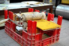 a machine that is sitting on top of some red pallets in the process of being made