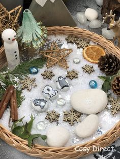 a basket filled with lots of different types of decorations and snowflakes on top of it