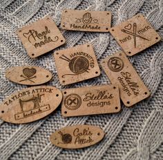 some wooden tags that are sitting on top of a blanket