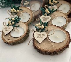 some candles are sitting on top of wood slices