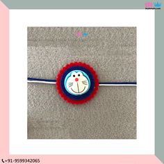 a blue and red headband with a cartoon cat on it's side sitting on the floor