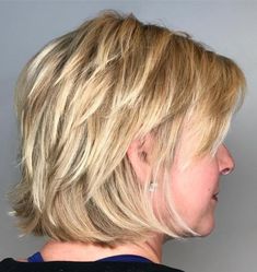 a woman with blonde hair is looking to the side and has her head tilted back