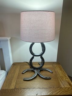 a lamp that is sitting on top of a wooden table next to a night stand