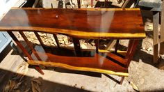 a wooden shelf sitting on top of a pile of wood