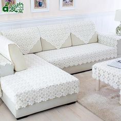 a white couch and ottoman in a living room