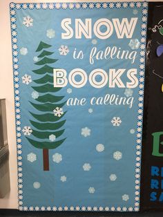 snow is falling books are calling bulletin board with christmas tree and santa hat on it