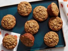 freshly baked muffins on a blue tray with polka dot napkin and orange dots