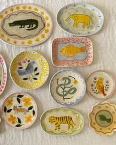 many plates with animals painted on them