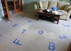 a living room with blue letters painted on the floor