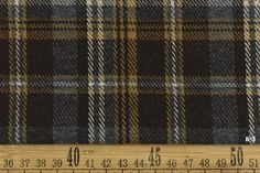 a ruler is next to a plaid fabric