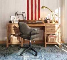 a desk with a chair and an american flag on the wall