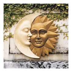 a sun and moon face on the side of a building