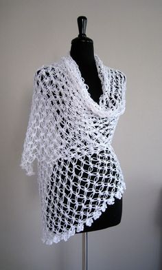 a white crocheted shawl on a mannequin