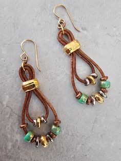 Czech glass Green Rembrandt beads combined with antique gold, antique silver, and antique copper beads and spacers on a double loop brown leather cord earring set. To keep beads, leather and all other components looking their best, avoid contact with water, lotions and perfumes. To access all other items in my shop, just hit the link here: https://www.etsy.com/ca/shop/KootenayLeatherRHS If you like jewelry, check out my other Etsy shop...it's jewelry for your door!  www.etsy.com/ca/shop/LaurasWr Green Beaded Earrings With Czech Glass, Beaded Brown Czech Glass Earrings, Green Czech Glass Beaded Earrings, Bohemian Multicolor Czech Glass Earrings, Artisan Green Czech Glass Earrings, Earring Dangle, Jewelry Glass, Contemporary Earrings, Boho Style Jewelry