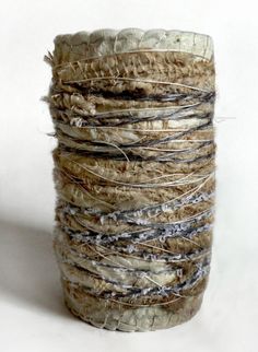 a stack of yarn sitting on top of a white table