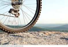 a close up of a bike tire on a rock