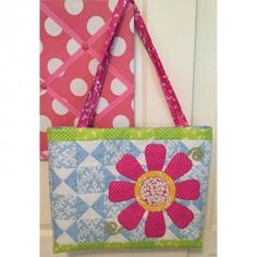 two purses hanging on the wall next to each other with polka dots and flowers