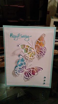 a birthday card with three butterflies on it