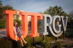 a woman is sitting on the letters that are in front of her