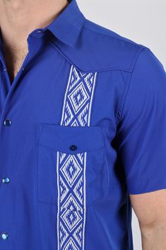 SIZE CHART Measurements: Model is wearing size Medium. Fit: Relaxed Fit Elevate your warm-weather wardrobe with our Men's Modern Guayabera Shirt, designed to keep you cool and stylish in the heat. Crafted from breathable and lightweight fabric, this shirt features traditional Aztec embroidery and four pocketed-details for added functionality. The relaxed camp collar and pintuck detailing offer a touch of sophistication, ensuring you look and feel your best no matter the occasion. Details & Featu Blue Long Sleeve Camp Shirt With Relaxed Fit, Blue Relaxed Fit Long Sleeve Camp Shirt, Blue Classic Camp Shirt With Relaxed Fit, Fitted Blue Short Sleeve Camp Shirt, Blue Fitted Short Sleeve Camp Shirt, Aztec Embroidery, Blazer And T Shirt, Guayabera Shirt, Aztec Design