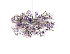 a chandelier with purple flowers hanging from it's center point on a white background