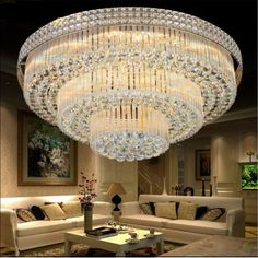 a living room filled with furniture and a large chandelier hanging from the ceiling