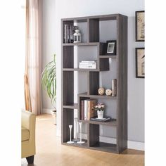 an open bookcase with several books on it in a living room next to a couch