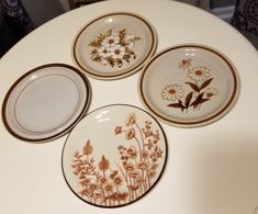 four plates sitting on top of a white table