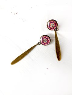 "AZIN Persian oriental Middle eastern dangle earring is handcrafted and features a historic tile pattern from an old Persian architecture. This earring is the perfect Christmas / Valentine's day/ birthday gift for your friend, sister, mother, bridesmaid, loved one, or a special treat just for yourself . The round bezel is in antique bronze tone made of Copper (Cadmium Free). Bezel size: about 0.5\" in diameter. It hangs down from ear approximately 2\" long including the dangling brass charm. REA Bohemian Nickel-free Jewelry For Mother's Day, Bohemian Teardrop Jewelry With Artistic Design, Pink Artistic Design Jewelry For Gift, Artistic Dangle Jewelry As Gift, Artistic Design Dangle Jewelry Gift, Artistic Dangle Jewelry For Gifts, Artisan Dangle Earrings As Gift, Artisan Dangle Earrings For Gift, Bohemian Brass Earrings With Artistic Design