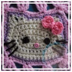 a crocheted hello kitty purse with a pink bow on it's head