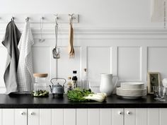 the kitchen counter is covered with dishes and utensils