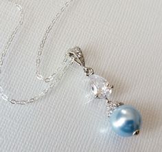 Light Blue Blush Blue Pearl Drop Silver Cubic Zirconia Wedding Bridal Pendant Necklace with .925 Sterling Silver Chain. PLEASE READ ITEM DESCRIPTION and SHOP POLICIES before placing your order, and contact me with any questions CHAIN is 20 inches (50.8cm) long. PENDANT is about 1.29 inch (3.3cm) long including bail. MATCHING EARRINGS: https://www.etsy.com/listing/529633883/blush-blue-pearl-earrings-light-blue?click_key=05ee615b36def4bf22e63d31c29c3cc1e7fccf02%3A529633883&click_sum=8b6b5e29&ref=s Elegant Light Blue Necklace For Anniversary, Elegant Light Blue Necklace For Wedding, Elegant Light Blue Wedding Necklaces, Elegant Light Blue Jewelry For Wedding, Elegant Blue Wedding Necklaces, Elegant Blue Wedding Necklace, Pink Pearl Wedding Jewelry, Jewellery Organization, Silver Necklace Wedding