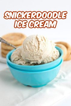 a blue bowl filled with ice cream next to crackers on a white tablecloth