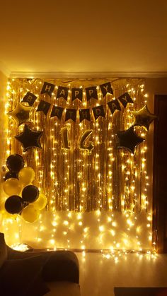 a room filled with balloons and streamers that say happy birthday