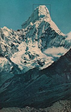 a large mountain covered in snow with a cross on it's peak above the clouds