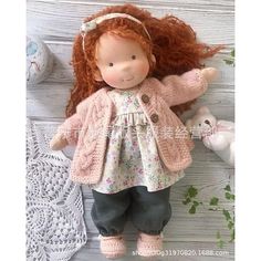 a doll with red hair is laying on the floor