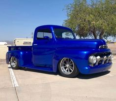 a blue truck parked in a parking lot