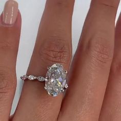 a woman's hand with a ring on it and a diamond in the middle