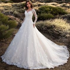 a woman wearing a wedding dress in the desert