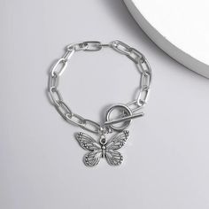 Introducing Our Stunning Butterfly Pendant Chain Bracelet Welcome to our store, where elegance meets affordability! Our Butterfly Pendant Chain Bracelet is a timeless piece that adds a touch of grace to any outfit. Crafted with precision and passion, this bracelet embodies the essence of charm. This bracelet is designed for the modern woman who appreciates beauty and quality. With its straight-line buckle chain and delicate butterfly pendant, it effortlessly blends Korean fashion sensibilities with international appeal. Embrace your femininity with this exquisite piece, perfect for both casual outings and special occasions. Product Features: Chain & Link Bracelet Made of high-quality zinc alloy Charming bowknot design Easy-hook clasp for convenience Available in a stunning silver color Lig Stainless Steel Chain Charm Bracelet, Trendy Alloy Bracelets For Gifts, Trendy Alloy Bracelets As Gift, Nickel Free Metal Chain Bracelet, Nickel-free Metal Bracelets, Metal Chain Bracelet For Gift, Adjustable Alloy Chain Bangle Bracelet, Adjustable Alloy Bangle Chain Bracelet, Dainty Metal Charm Bracelet With Chain