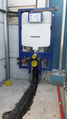 a water heater sitting in the middle of a room with pipes running through it