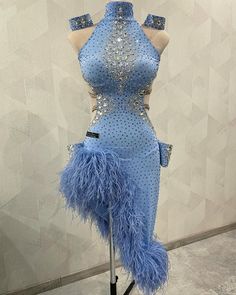 a mannequin dressed in blue with feathers on it