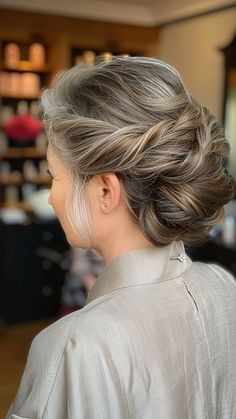 a woman with grey hair in a bun