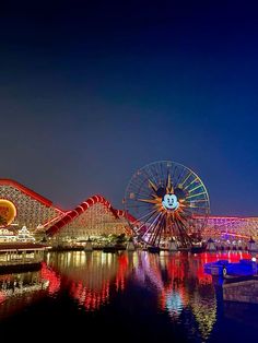 the amusement park is lit up at night