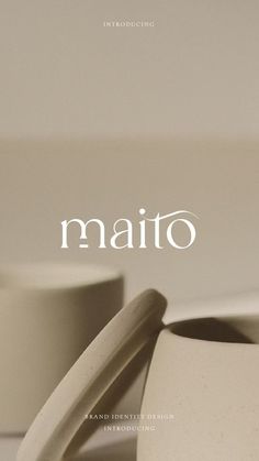 two white cups sitting on top of a table next to each other with the word mato written above them