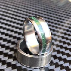 Rush order option: Some of our rings can be expedited from the normal 3 week lead time to either 3 day or same-day shipping with a rush order add on. Rings with these liners cannot be expedited: Tungsten, Ceramic, Stainless steel, Damascus, and coin rings.  All other Liners can be expedited.Link below:https://www.etsy.com/listing/718766382/add-on-rush-order?ga_search_query=add&ref=shop_items_search_1&frs=1This stunning 8mm ring is crafted out of a solid piece of titanium. It has an intense green Gemstone Wedding Band, Coin Rings, Gemstone Wedding, Natural Emerald Rings, Coin Ring, Mystic Topaz, Titanium Rings, Tungsten Ring, Domed Ring